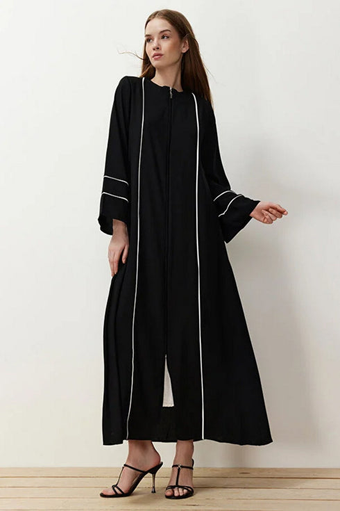 Black front open abaya in black firdaus with white piping and flared sleeves